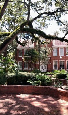 a large red brick building surrounded by trees