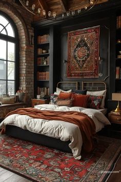 a large bed sitting under a window next to a book shelf filled with books on top of a rug