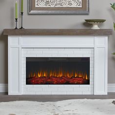 a white fireplace with an electric fire in it and a flat screen tv on the wall