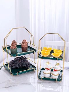 three tiered trays filled with cupcakes and pastries on top of a table