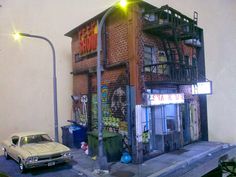 a car parked in front of a building with graffiti on it