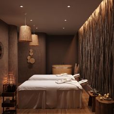 a spa room with two large beds in it