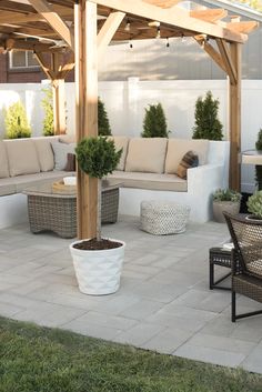 an outdoor living area with couches and tables