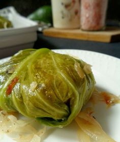 a white plate topped with cabbage covered in sauce