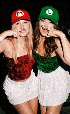 two young women dressed in costumes posing for the camera