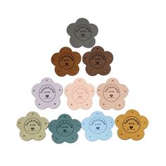 six flower shaped tags with different colors and designs