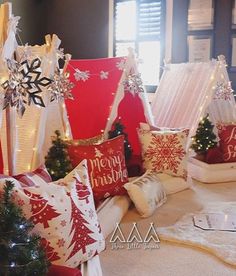 pillows and christmas decorations are on display in front of the window, with snowflakes all over them