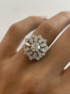 a woman's hand with a diamond ring on it