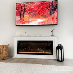 a fireplace with a painting on the wall above it and a basket next to it