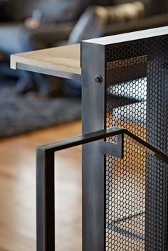 a metal table with a wooden top on a hard wood floor