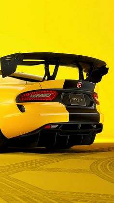 the rear end of a yellow sports car