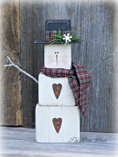 a snowman made out of wooden blocks on top of each other