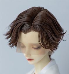 a mannequin head with a veil over it's face and hair in the shape of a wig