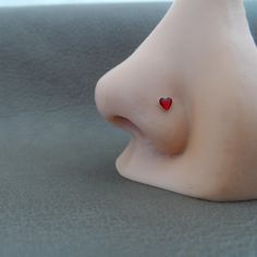 a close up view of a plastic nose with a red heart on it's side