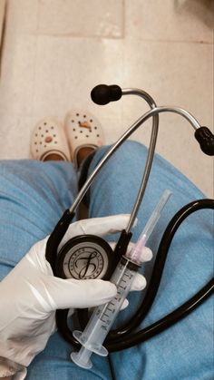 a doctor's stethoscope is being held by someone in white gloves