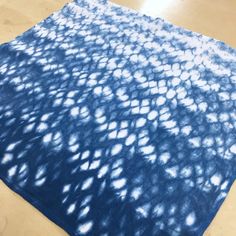 a blue and white area rug sitting on top of a wooden floor