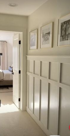 an open door leading to a bedroom with pictures on the wall