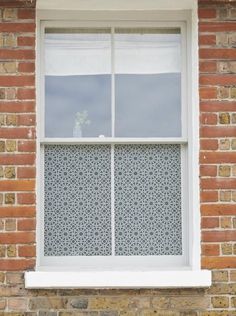 a brick building with a white window on the side