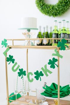 a bar cart filled with drinks and shamrock decorations