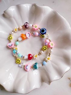 the bracelet is decorated with colorful beads and smiley faces