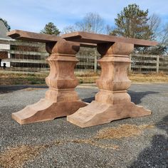 two wooden pillars sitting on top of gravel