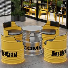 three yellow barrels sitting on top of a floor next to each other in front of a bar