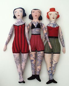 three mannequins with tattoos on their arms and legs standing next to each other