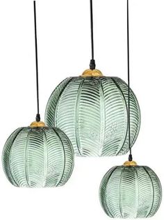 three green glass pendant lights hanging from black cords