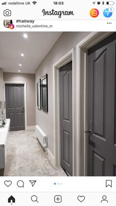 an instagram photo of a bathroom with gray doors and white fixtures on the walls