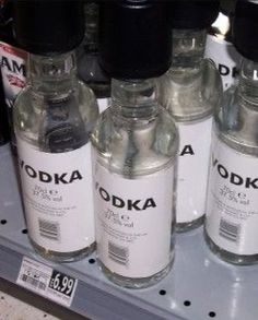 bottles of vodka are on the shelf for sale in a store or convenience store,