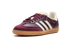 The Women’s adidas Samba OG “Maroon/Cream White” is a women’s-exclusive colorway of the classic indoor soccer shoe with a maroon-based appearance.  The upper features a maroon leather base with a tonal suede overlay on the toe.  Cream White Three Stripes branding appears on both sides, while a gold “Samba” logo can be found on the lateral side of the midfoot.  Gold adidas branding appears on the Cream White tongue.  Underfoot, a gum rubber sole rounds out the look. Adidas Shoes Samba, Maroon Shoes, Custom Sneakers Diy, Adidas Sl 72, Adidas Samba Og, Burgundy Shoes, Maroon Leather, Adidas Spezial, Nike Dunk High