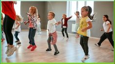 a group of young children dancing in a dance studio