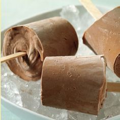 three pieces of chocolate covered marshmallows on a plate with a toothpick