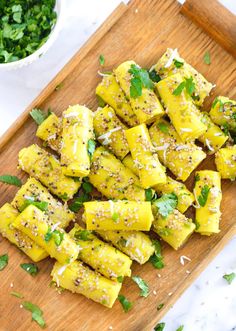 a wooden cutting board topped with sliced up pineapples and parmesan cheese