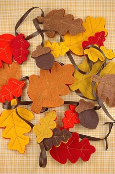 a pile of felt leaves sitting on top of a table