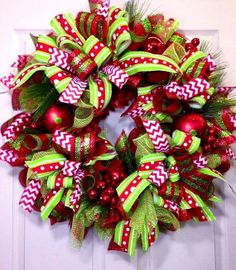 a christmas wreath with red and green decorations