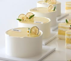 there are four pieces of cake with lemon slices on them and one slice is cut in half