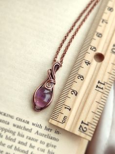 This is a cute and tiny pendant with a natural lavender amethyst stone. Simple and easy to wear, it is a timeless and sweet pendant. The metal part is solid copper that has been oxidized for an antique look. • Pendant size : H 3 x W 1.2 cm 🎁 This pendant comes with a free 18" copper chain necklace. Ready to wear or give as a gift. ✨ One-of-a-kind item ✨ There is only one of these. You will get the exact pendant as seen in the photos. CARE INSTRUCTION • Wire-wrapped jewellery is delicate, please Mini Wire Wrapped Pendant, Wire Wrapped Donut Pendant, Simple Wire Wrapped Pendant Tutorial, Wire Wrapped Jewelry Tutorials Easy, Wire Necklace Ideas, Diy Wire Pendant, Easy Wire Wrapping Stones, Wire Wrapped Bead Pendant, Wire Wrapped Pendant Tutorial