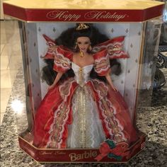 a barbie doll in a red and white dress with gold trimmings on it's head