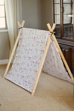 a teepee tent sitting in front of a china cabinet