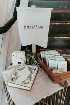 a basket filled with lots of money sitting on top of a wooden table next to stairs