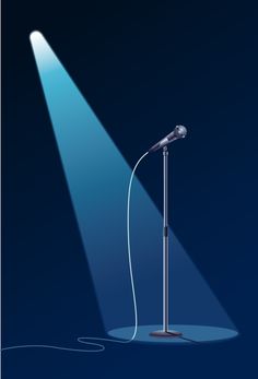 a microphone on a stand with a light coming from the top and floor behind it