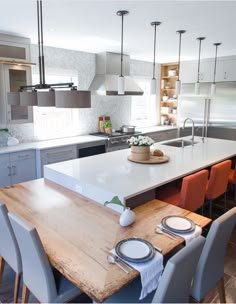 the kitchen table is set with plates and place settings