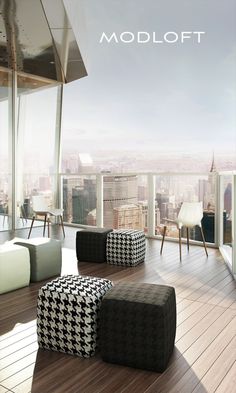 a living room filled with furniture next to a large window overlooking a cityscape