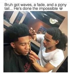 a man getting his hair cut by another man in a barbershop at the same time