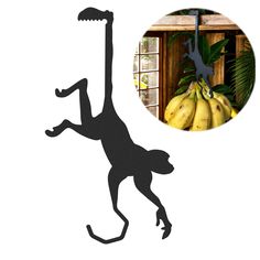 a black silhouette of a monkey with bananas in the background and a photo of a banana tree