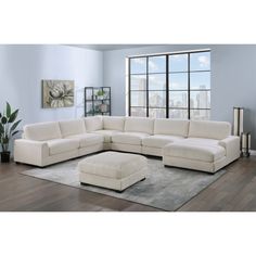 a living room with a sectional couch and ottoman