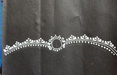 a black piece of cloth with white designs on it