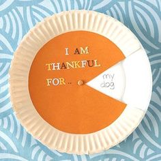 an orange and white paper plate with the words i am grateful for it on it