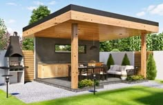 an outdoor kitchen and dining area in a backyard with grass, shrubs, and trees